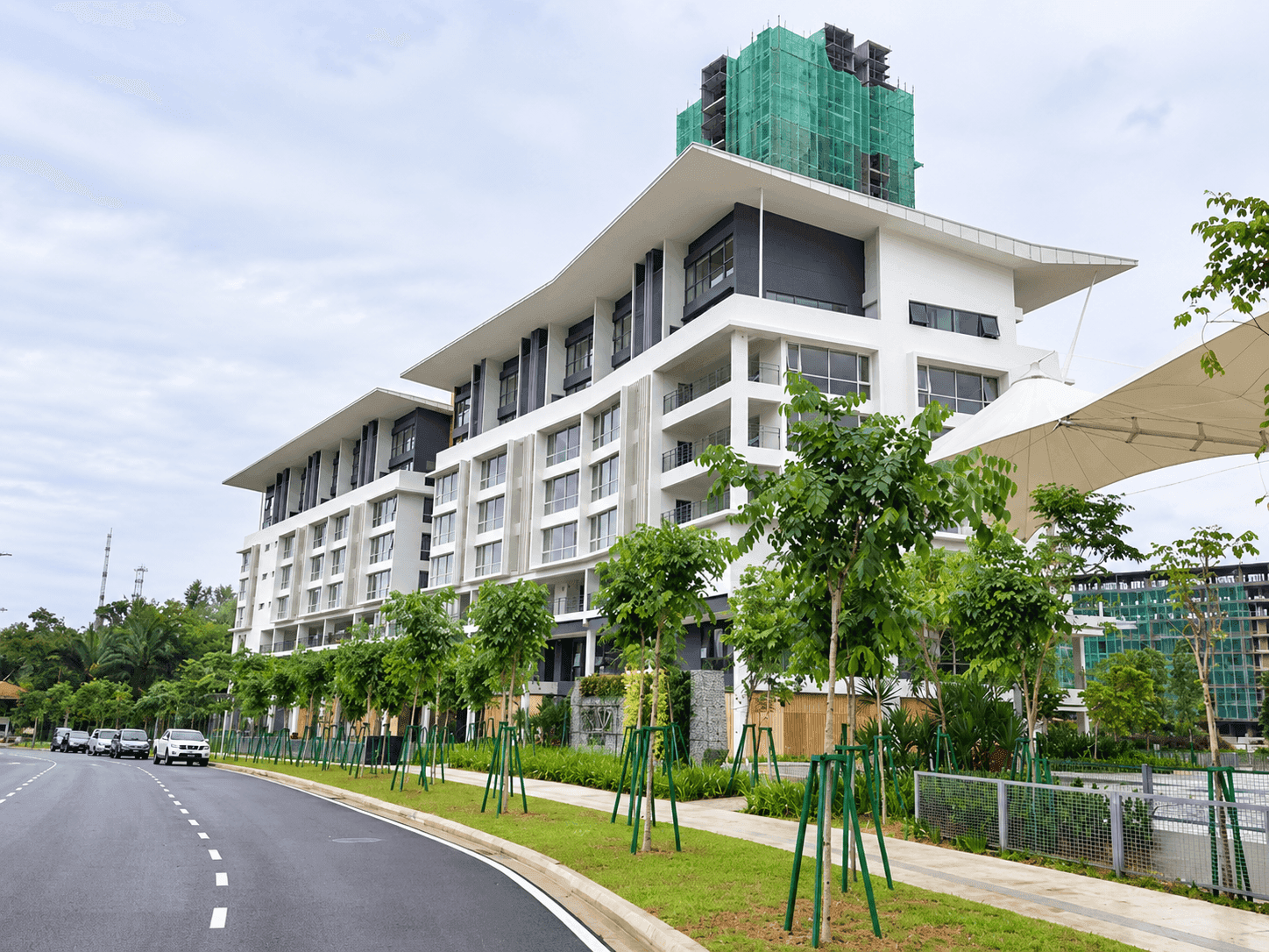 A newly completed low-rise development in Sri Damansara, Selangor, with young roadside trees along a fresh carriageway