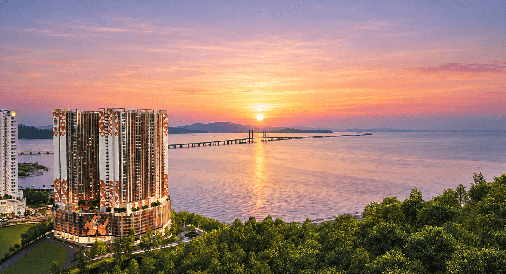 M Amaya residential towers overlooking the waterfront and sea bridge at sunset
